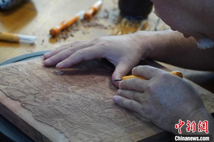 圖為徐晉林湊近木板，近距離制作雕版畫?！【琶赖┰?　攝