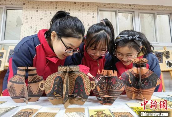 圖為學(xué)生用紙創(chuàng)作的立體彩陶?！⒂裉?攝